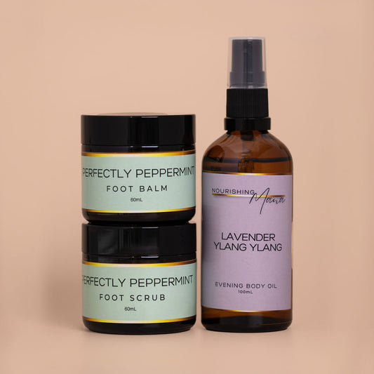 Body Care Essentials Bundle featuring Perfectly Peppermint Foot Scrub, Foot Balm and Lavender Ylang Ylang Body Oil for soft, nourished skin.