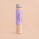 Clay Detox Bath Soak with lavender and ylang ylang in a glass tube on a beige background