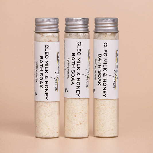 Three Cleo Milk & Honey Bath Soaks in reusable glass tubes by Nourishing Mana.