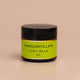 Nourishing Mana Margarita Lime Foot Balm in a 60ml amber glass jar with a black lid on a beige background.