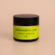 Nourishing Mana Margarita Lime Foot Scrub in a 60ml amber glass jar with a black lid on a beige background.